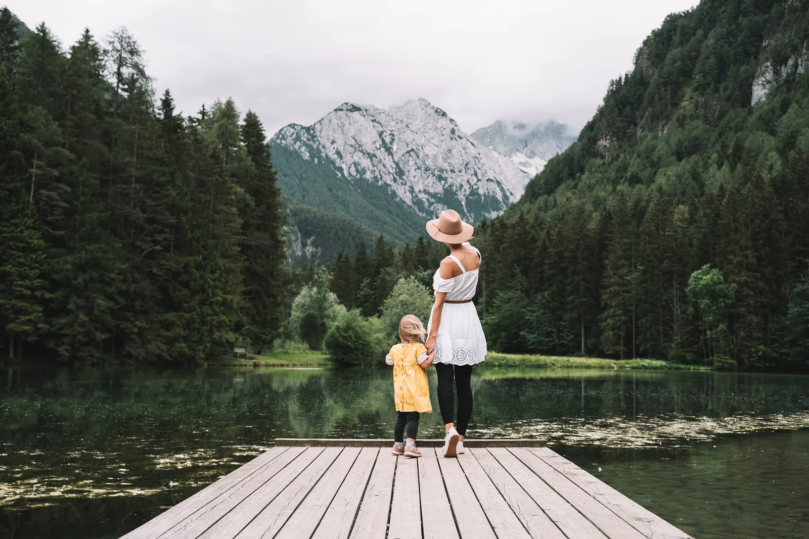 Woman and child on a dock, a thoughtful journey with website design.