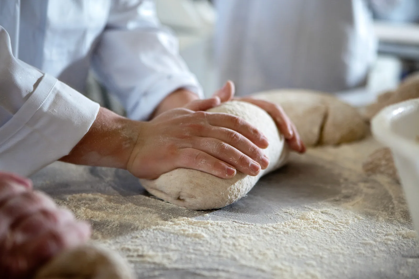 Expert hands shaping dough for bespoke quality website design.
