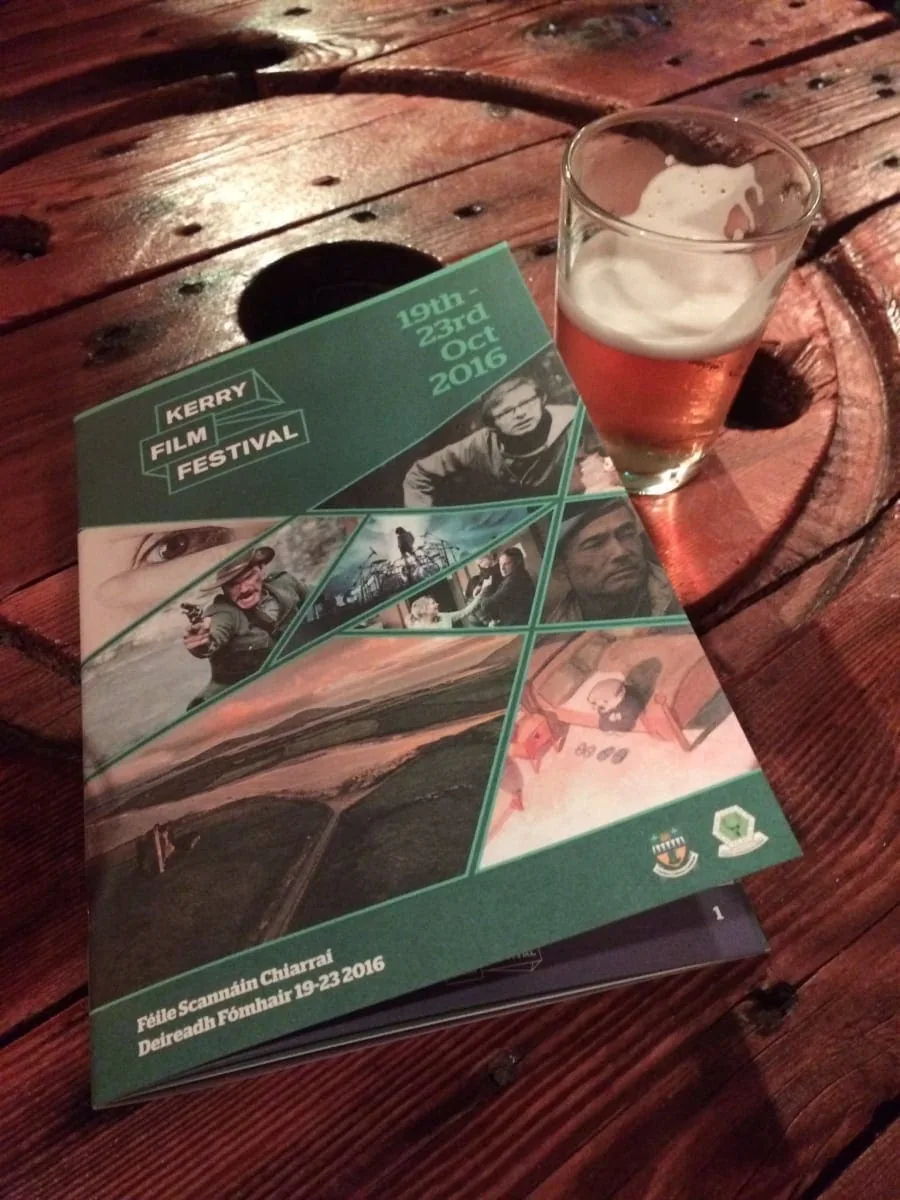Kerry Film Festival program with a beer on a wooden table, website design.