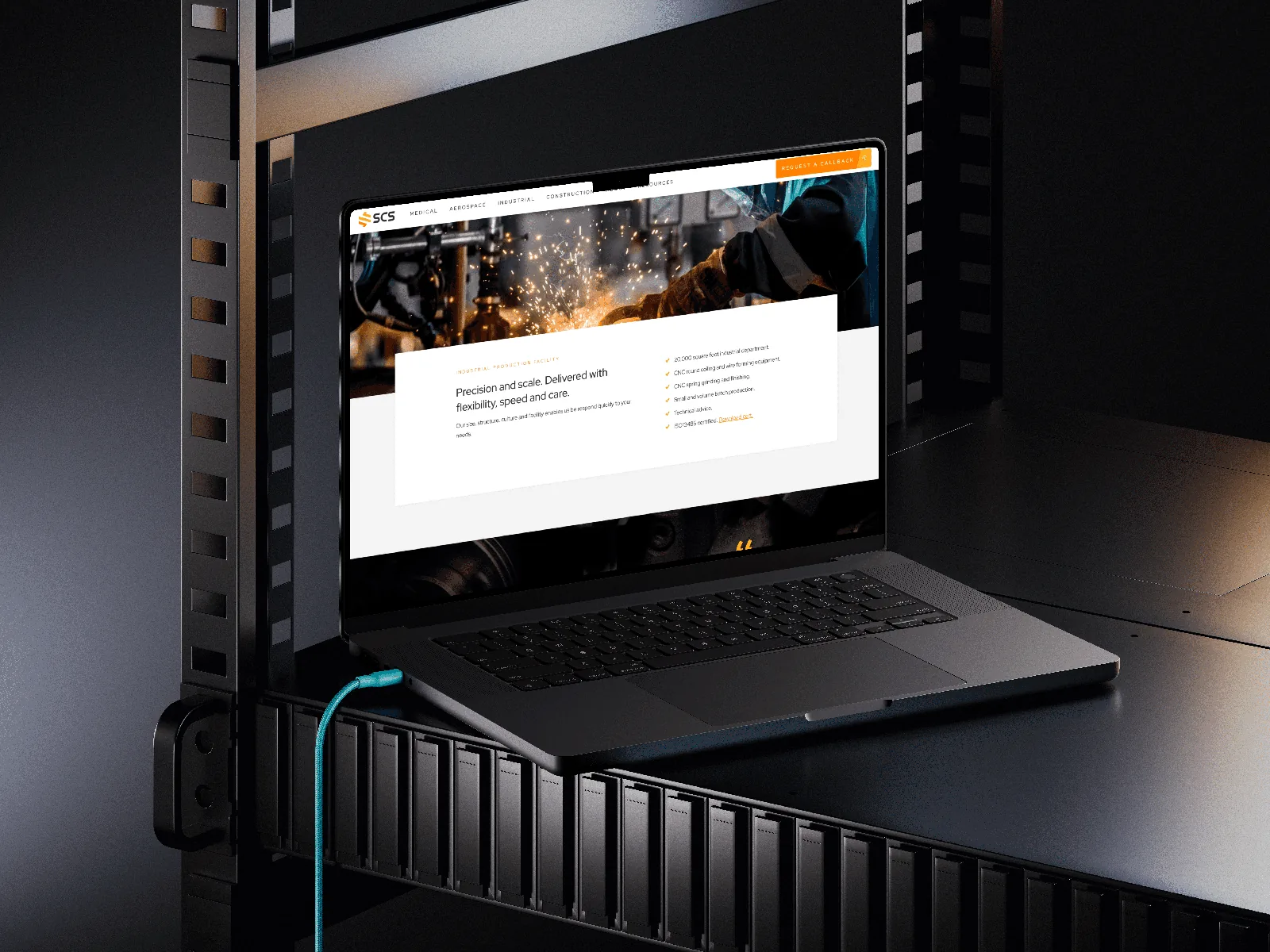 Shannon Coil Springs industrial website displayed on a laptop in a dark technical setting