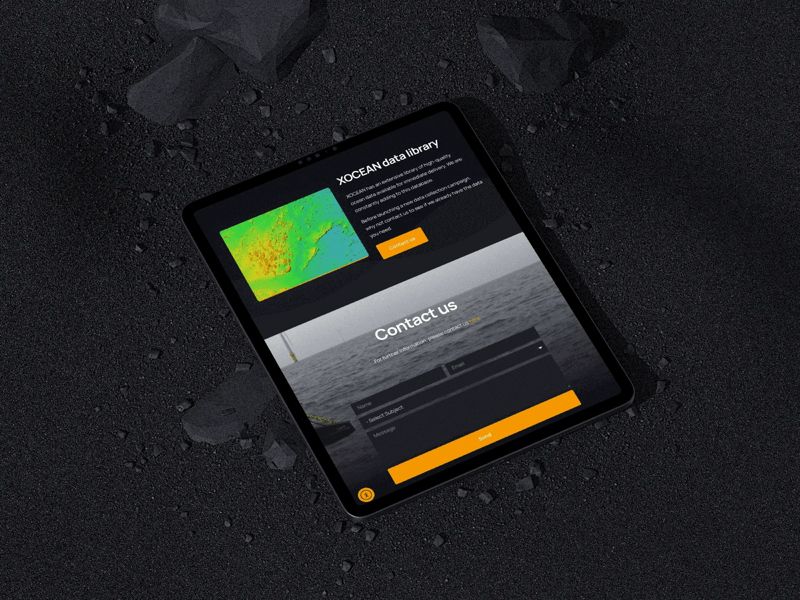 XOCEAN ocean-data website shown on a tablet against a dark textured surface